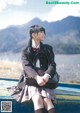 A woman in a school uniform sitting on a boat.