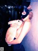 A woman in a bunny mask holding a rabbit.