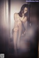 A woman sitting on top of a wooden cabinet.