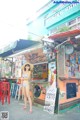 A woman in a bikini standing in front of a restaurant.