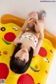 A little girl laying on top of an inflatable pizza.