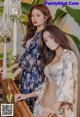 Two young women standing next to each other on a staircase.