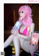 A woman in a pink bikini holding a bottle of water.