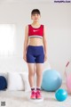 A woman standing on a balance board in a living room.