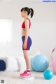 A woman standing on a balance board in a living room.