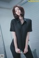 a woman in a black shirt and black pants posing for a picture